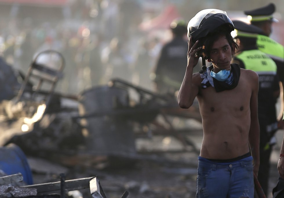 Un joven se quita su casco durante las labores de rescate después de la explosión en el mercado de pirotecnia de Tultepec