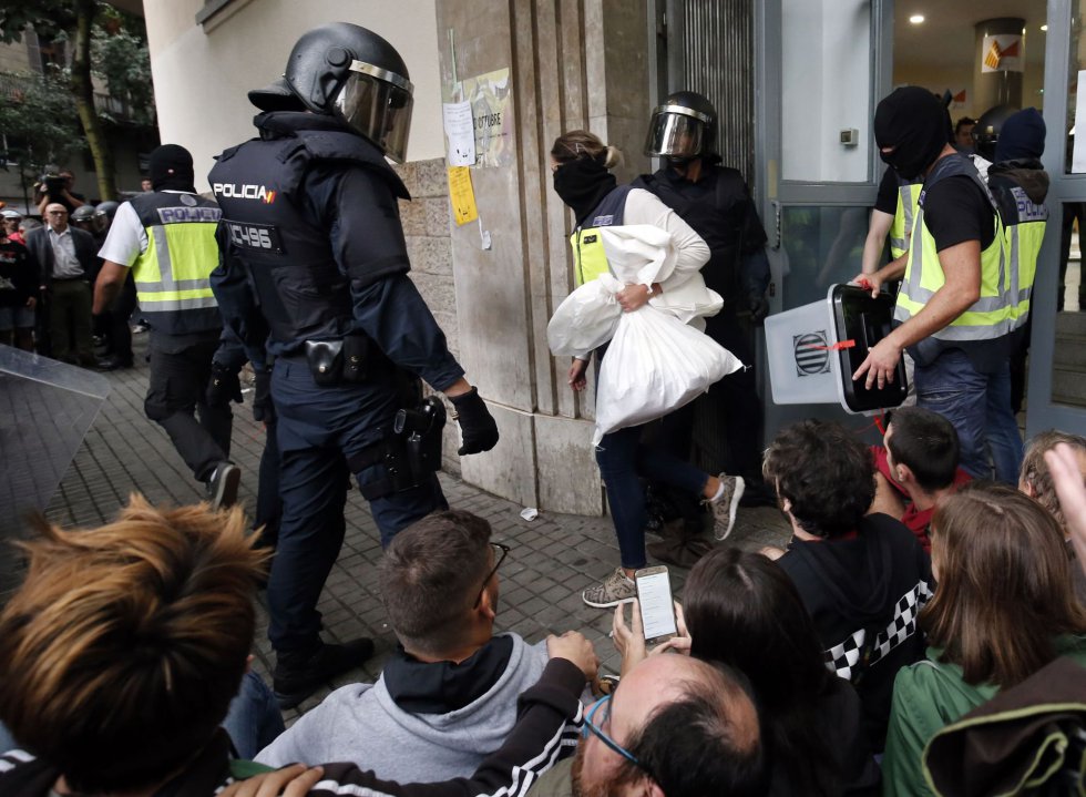 La policía se lleva las urnas de una mesa de votación en Barcelona.