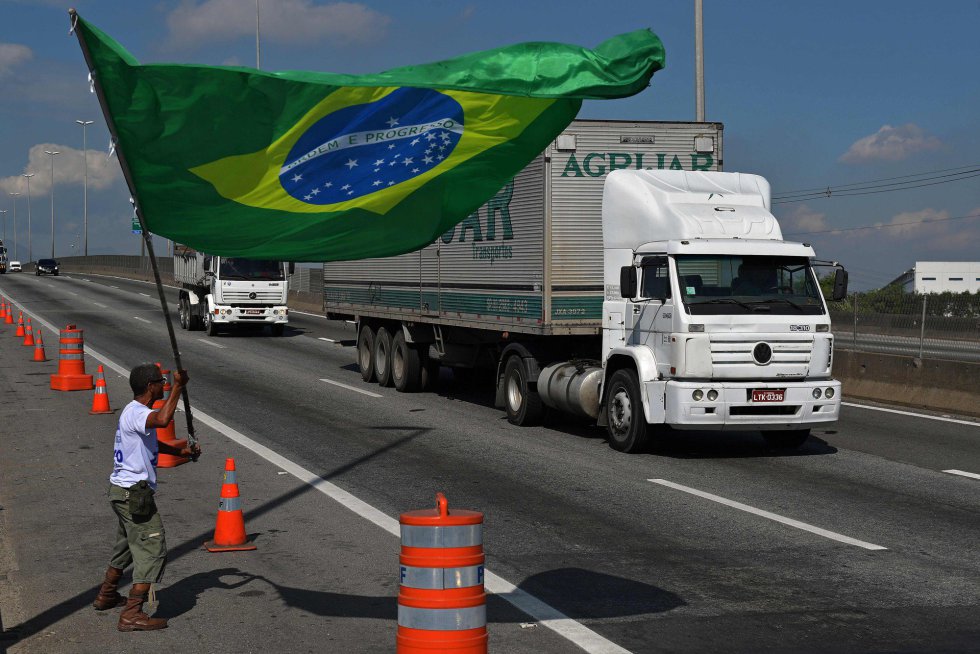 La huelga de camioneros brasileÃ±os contra el aumento del precio del diÃ©sel comenzÃ³ a perder fuerza despuÃ©s de ocho dÃ­as de bloqueos que paralizaron a la mayor economÃ­a de AmÃ©rica Latina y sacudieron a su impopular gobierno. En la imagen, un manifestante con la bandera nacional de Brasil en el exterior de unarefinerÃ­a en RÃ­o de Janeiro, el 28 de mayo de 2018.