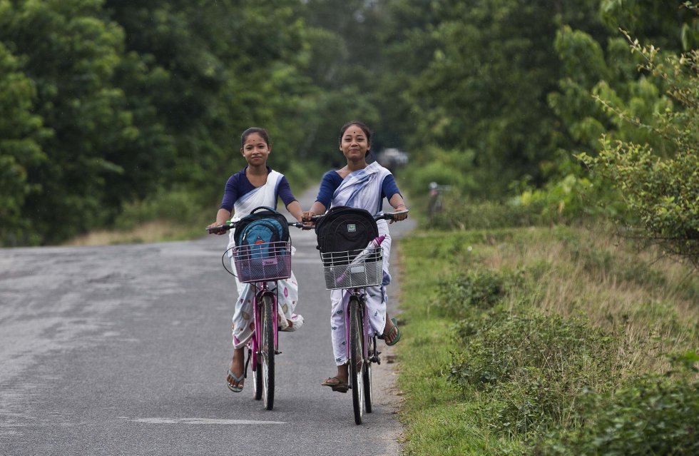 Dos niñas regresan a casa en bicicleta desde la escuela en las afueras de Gauhati, India, el 24 de agosto de 2018. Las bicicletas son un medio de transporte común para los estudiantes en gran parte de las áreas rurales en el noreste de la India.