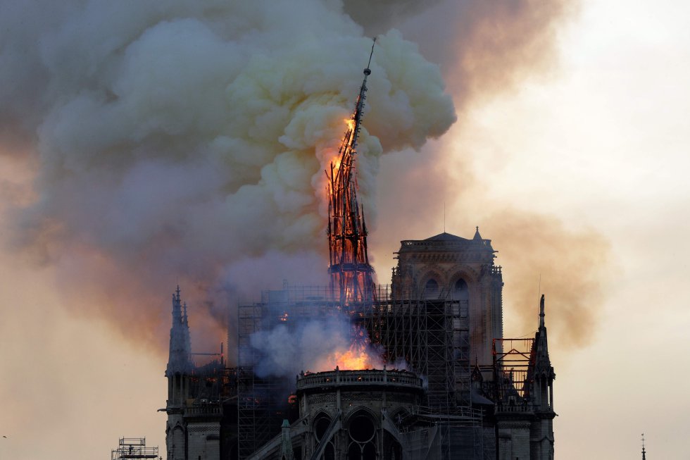 La catedral de Notre Dame de París sufre este lunes un gravísimo incendio, que ha derribado ya su emblemática aguja y parte del techo. En la foto, momento en que se desploma la aguja de la catedral.