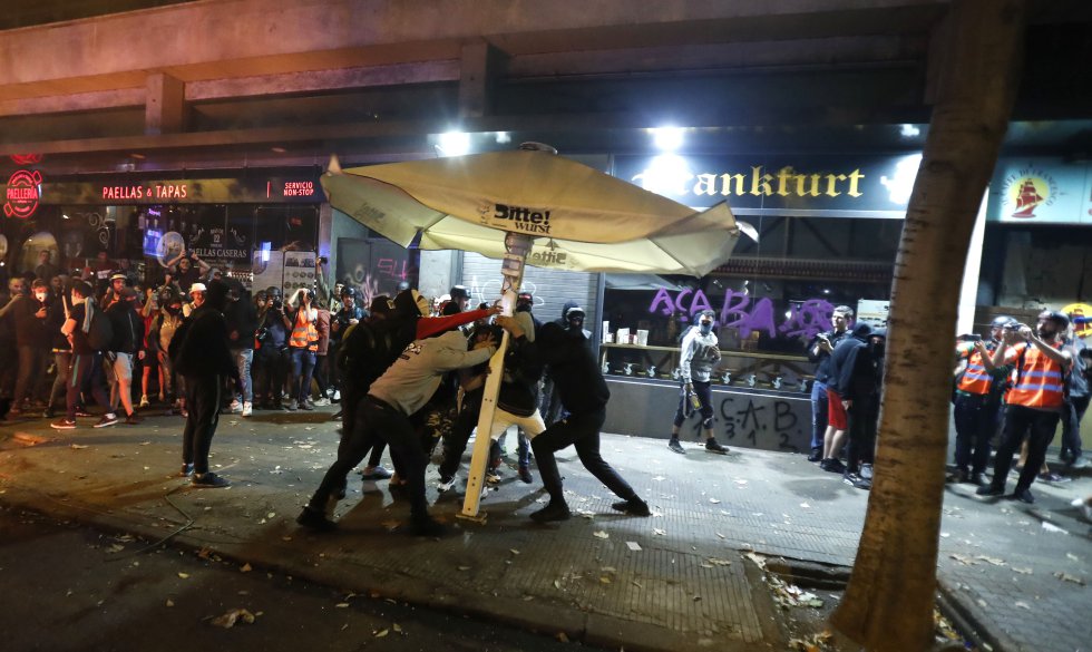 Algunos manifestantes han logrado encender una barricada. No hay contenedores ni casi nada que puedan usar, así que han cogido mobiliario de un restaurante, plantas, basura y lo que han encontrado. .
