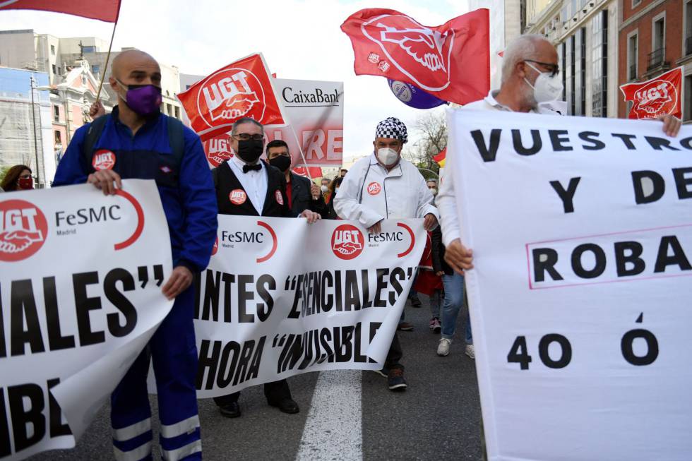 Um grupo de pessoas durante o Dia Internacional do Trabalho marcha pelas ruas de Madrid.