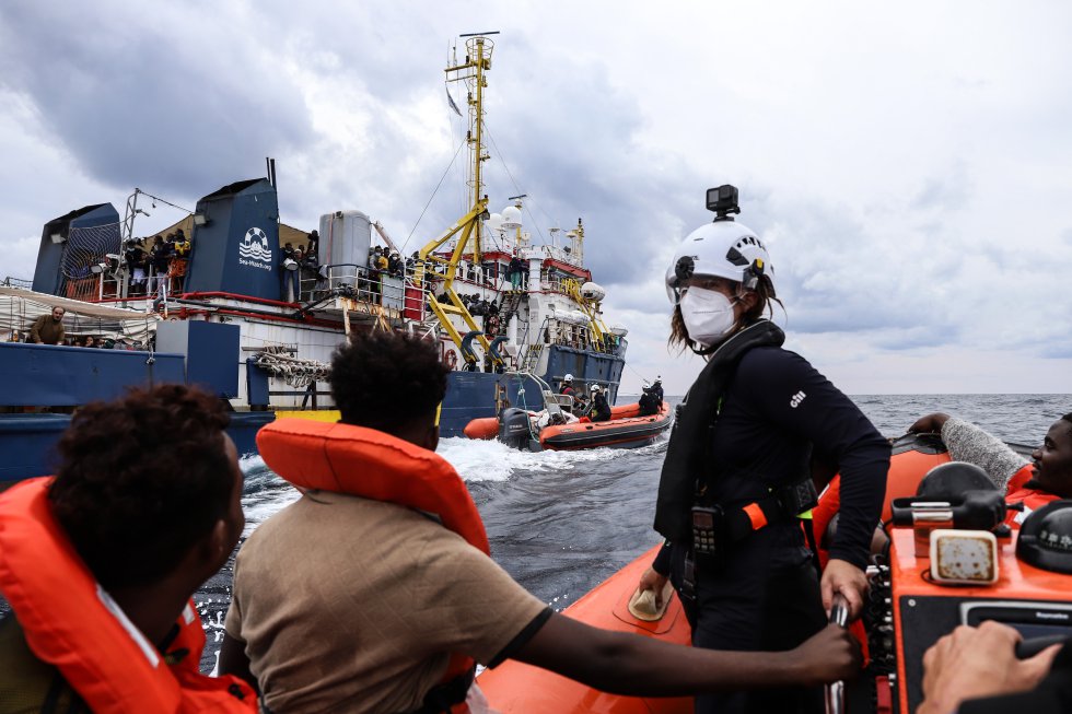 Migrantes sentados en la lancha de salvamento del 'Sea Watch 3', esperando a subir a bordo del barco humanitario.