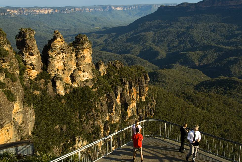 A menos de dos horas en coche o en tren de Sídney se extiende uno de los parques nacionales más espectaculares de Australia, el de las Montañas Azules. Su nombre deriva de la bruma azulada que envuelve su paisaje, producida por los aceites que los bosques de eucaliptos que lo alfombran liberan en la atmósfera. Cañones, valles profundos, cascadas de agua y la famosa formación rocosa de Las Tres Hermanas (en la imagen), con leyenda incluida: tres hermanas de la tribu katoomba, Wimlah, Meehni y Gunnedoo, convertidas en piedra por enamorarse de quienes no debían.